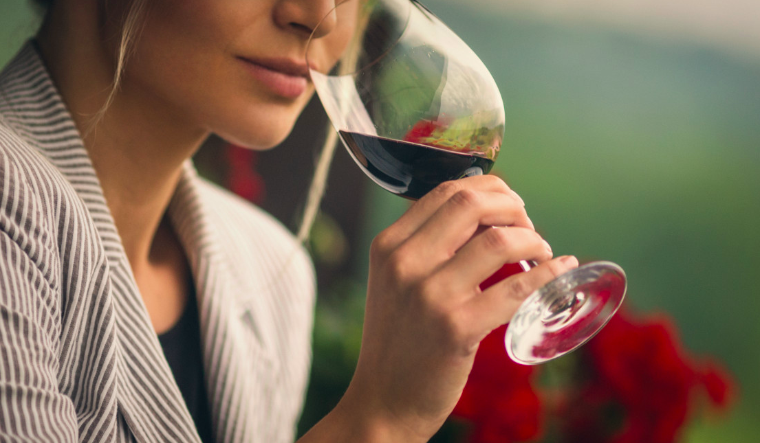 Woman sipping alcohol