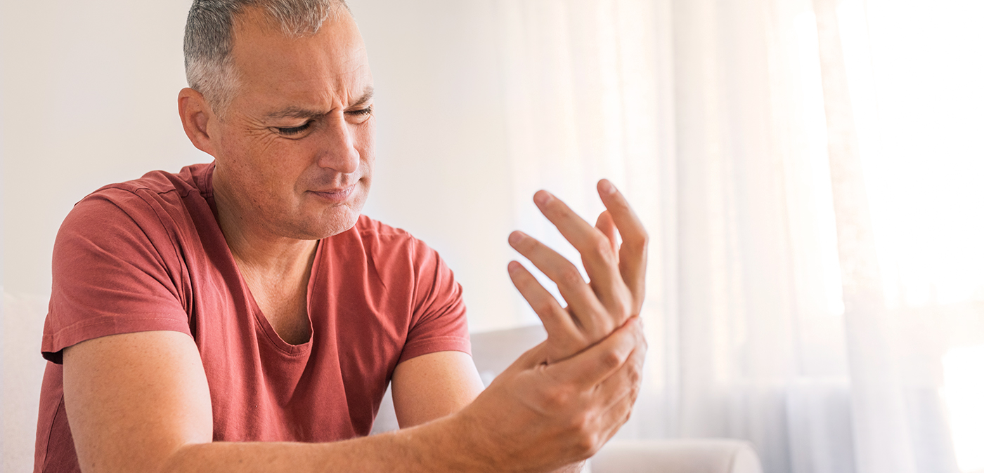 Man experiencing pain in his left hand