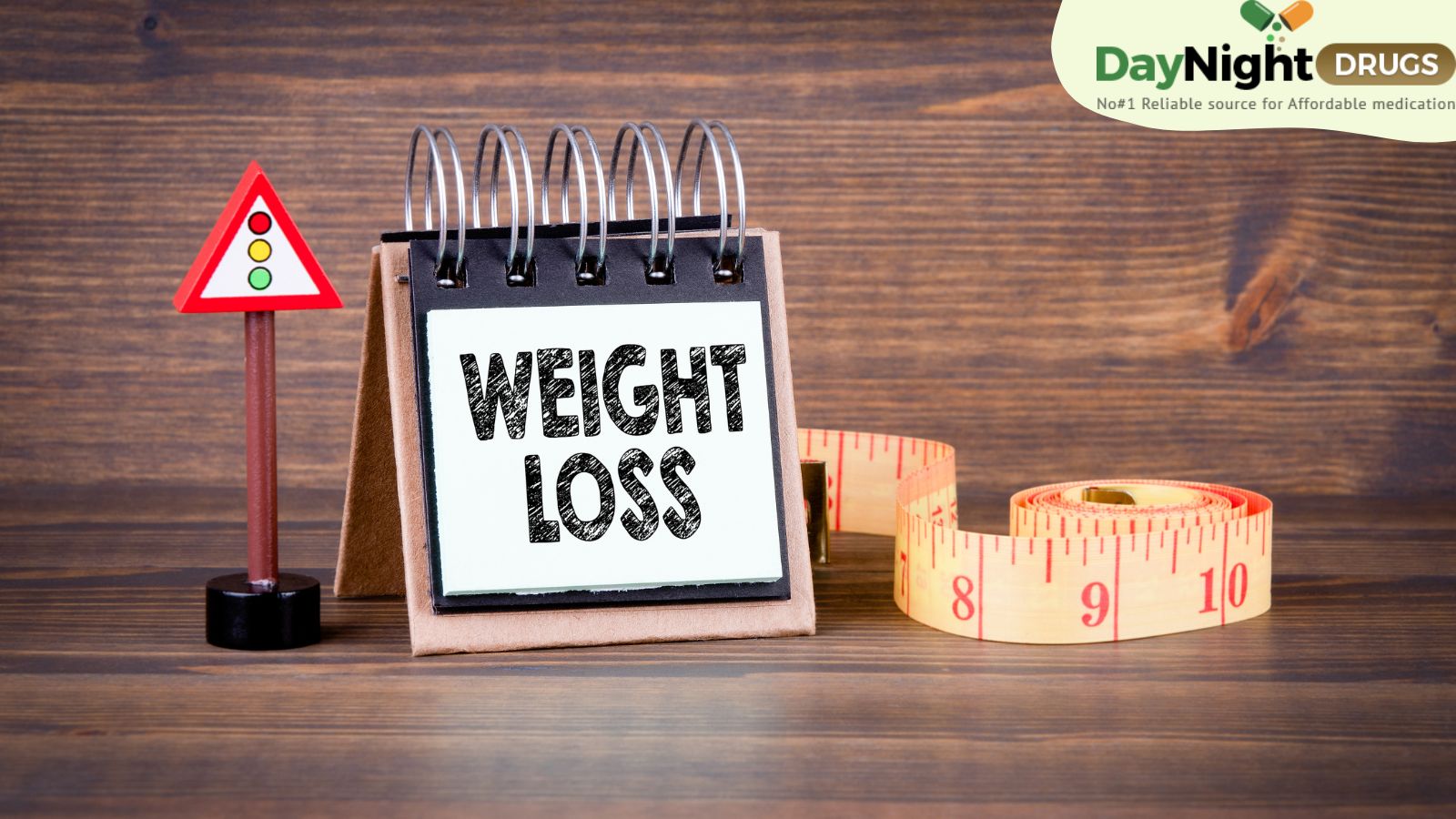A calendar stating Weight Loss and a measuring tape