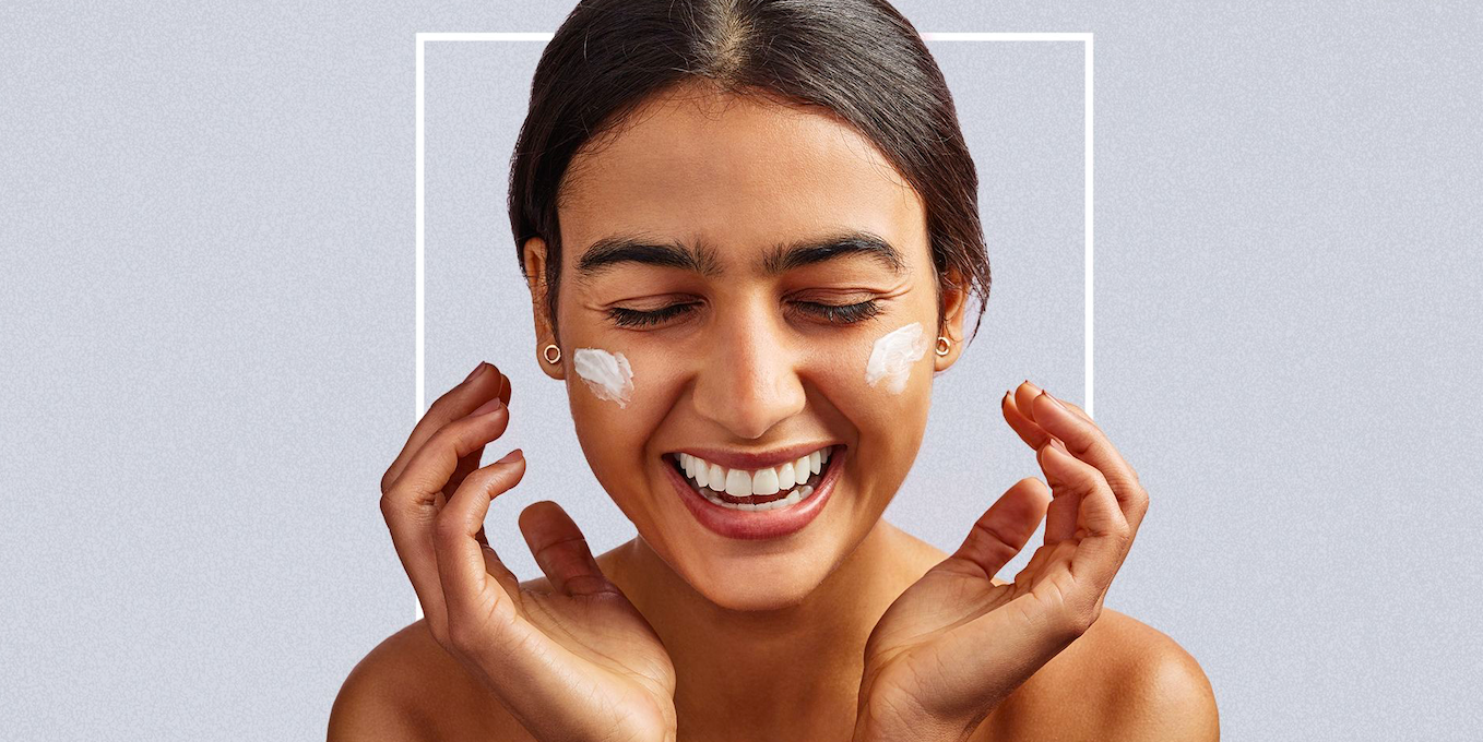 Girl smiling while applying cream