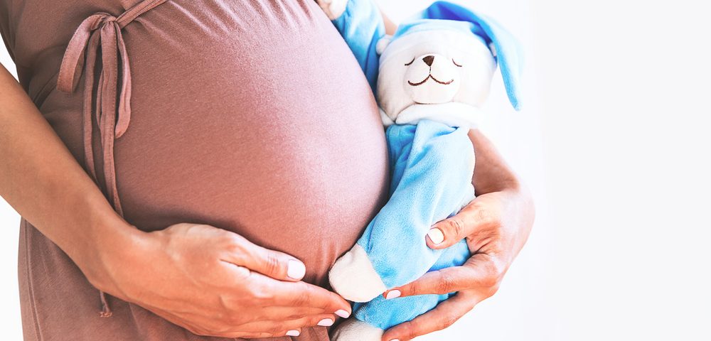 Pregnant women with a teddy bear